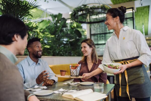 Guests enjoying meals on the garden terrace of Atrium restaurant Voco Hotel