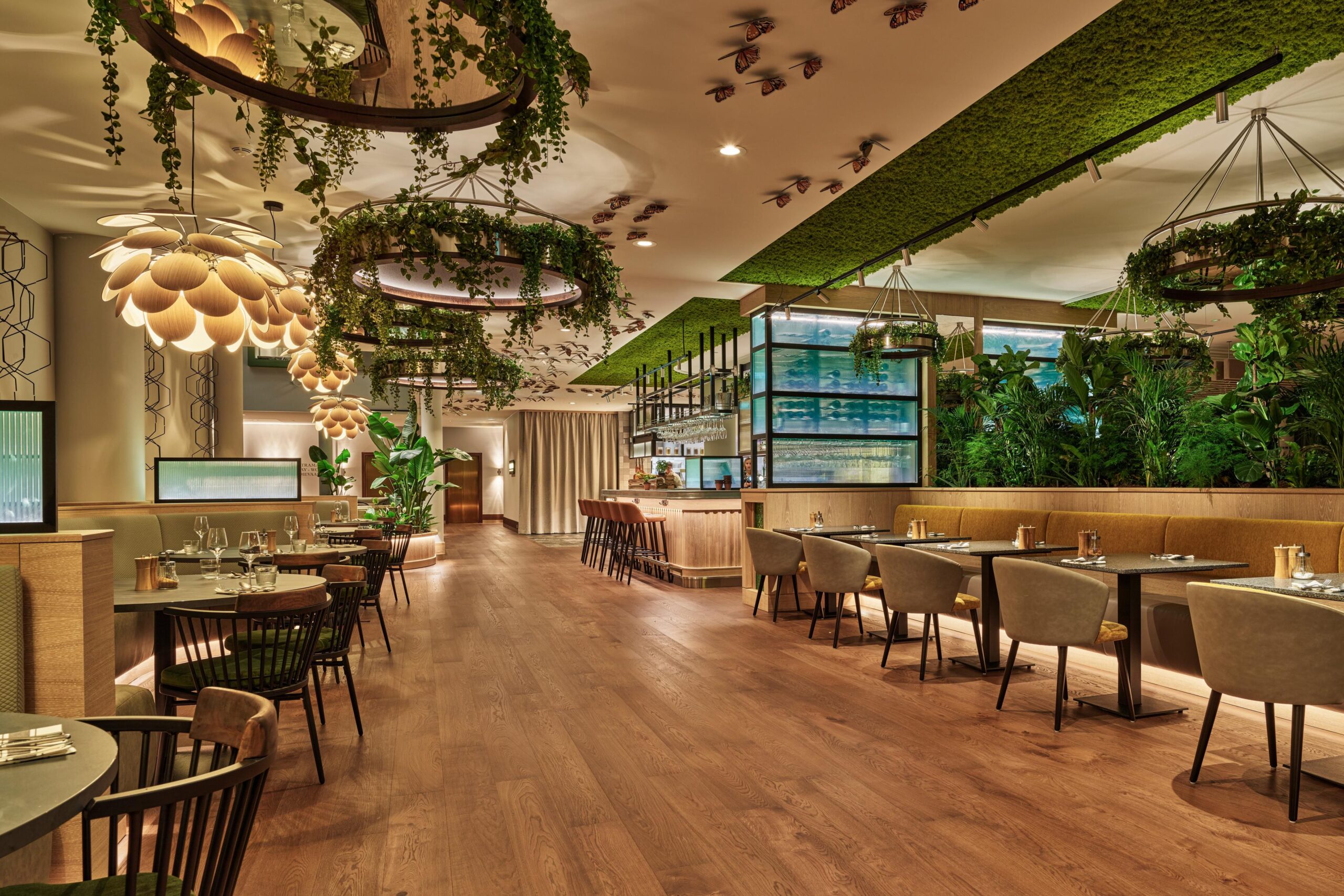 Elegant interior of Botanica restaurant bar and lounge with modern décor and lush greenery.