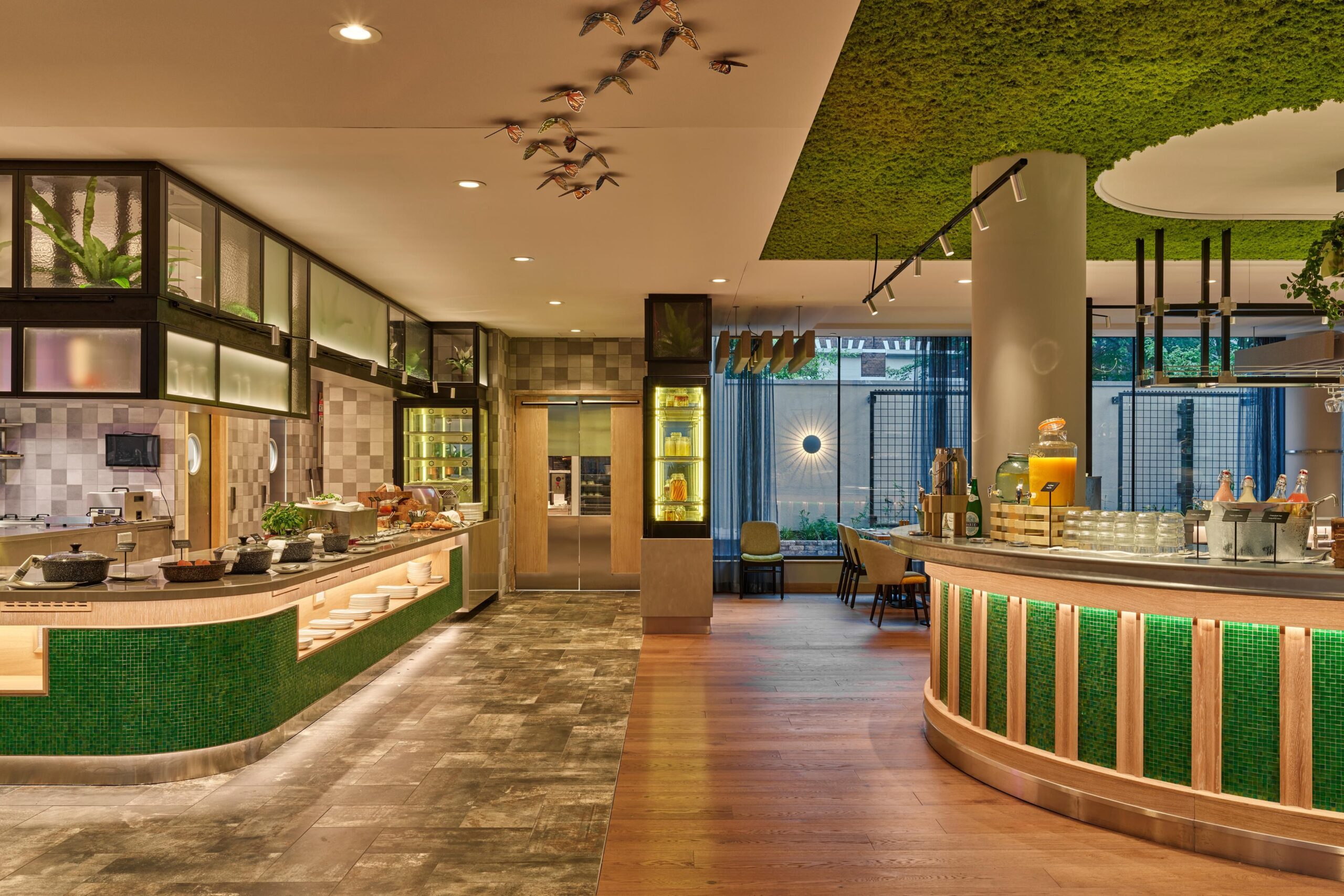 Assorted breakfast items including pastries, fruits, and beverages at Voco botanica restaurant