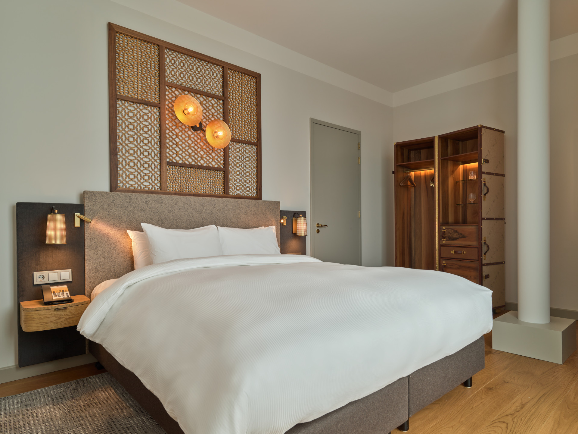 Elegant King-size bed in the suite at voco The Hague with contemporary decor