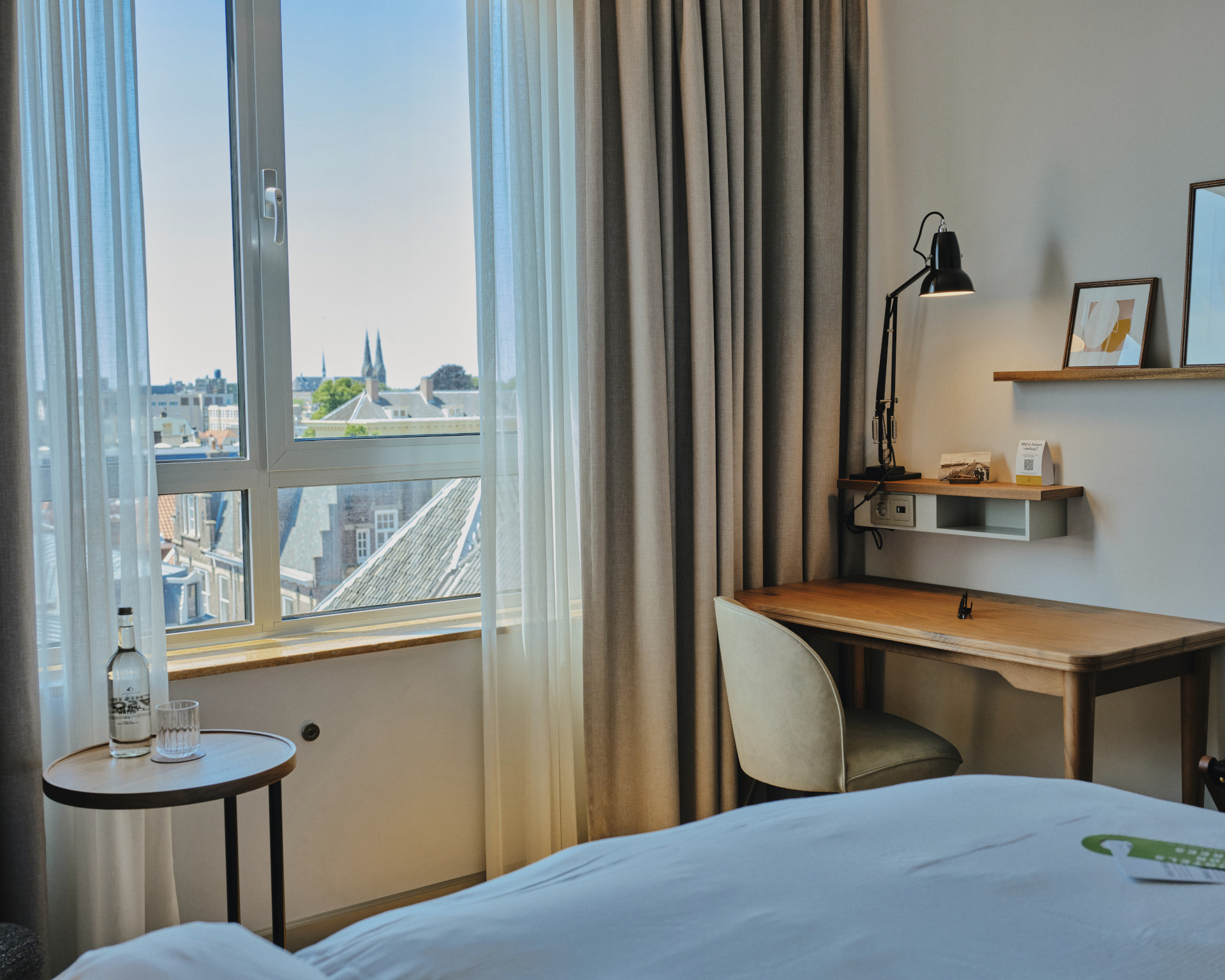 Queen Bed Premium room with balcony and city view at voco The Hague.