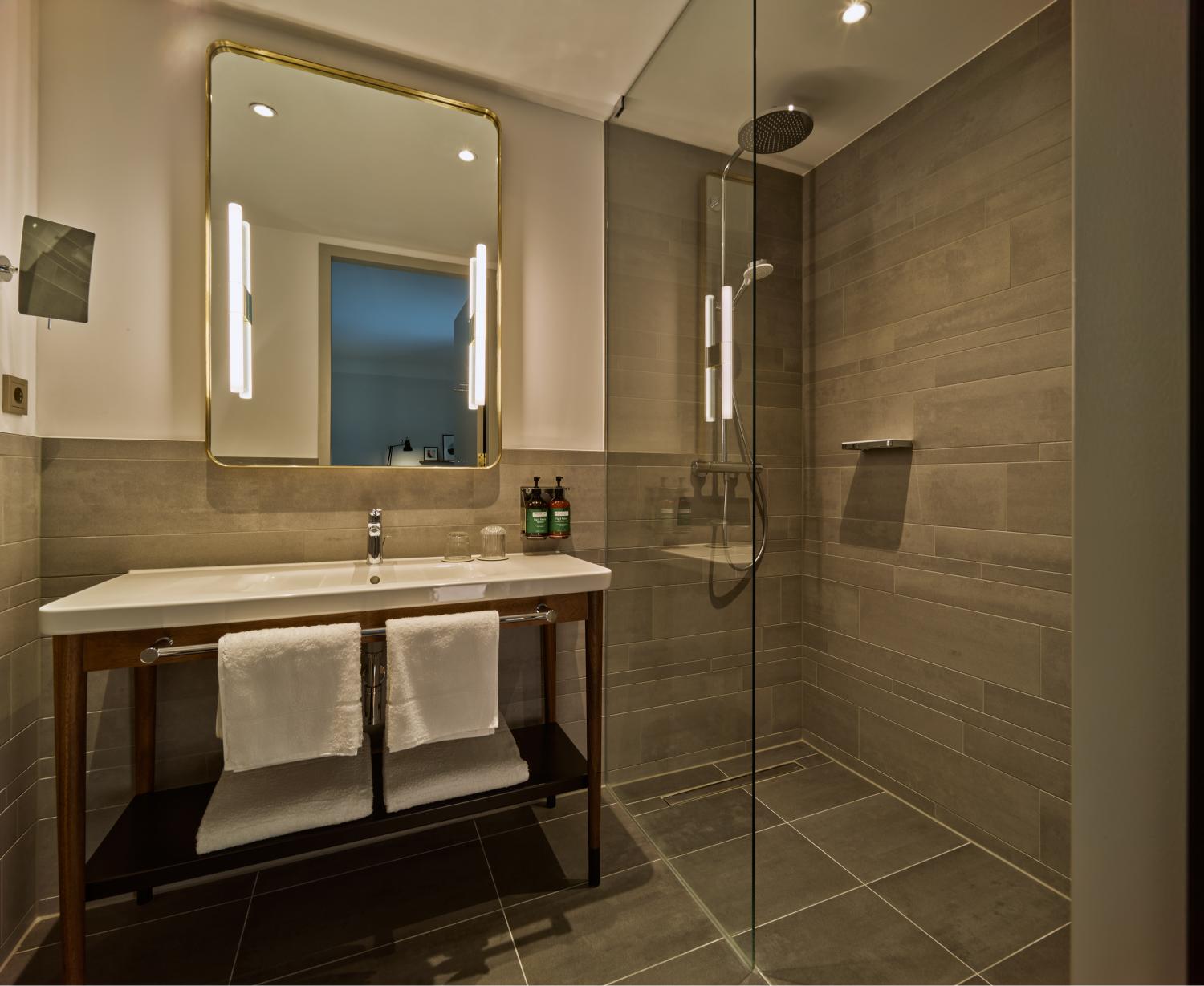 Walk‑in rain shower in King Suite bathroom at voco The Hague