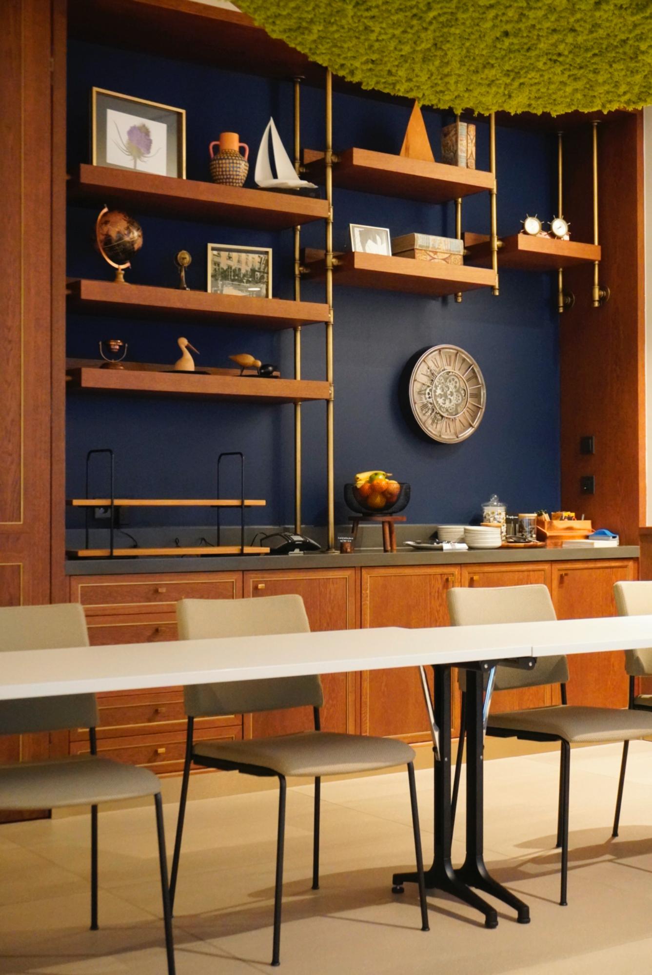 Elegant wooden wall shelving and coffee station in De Reiger meeting room at voco The Hague